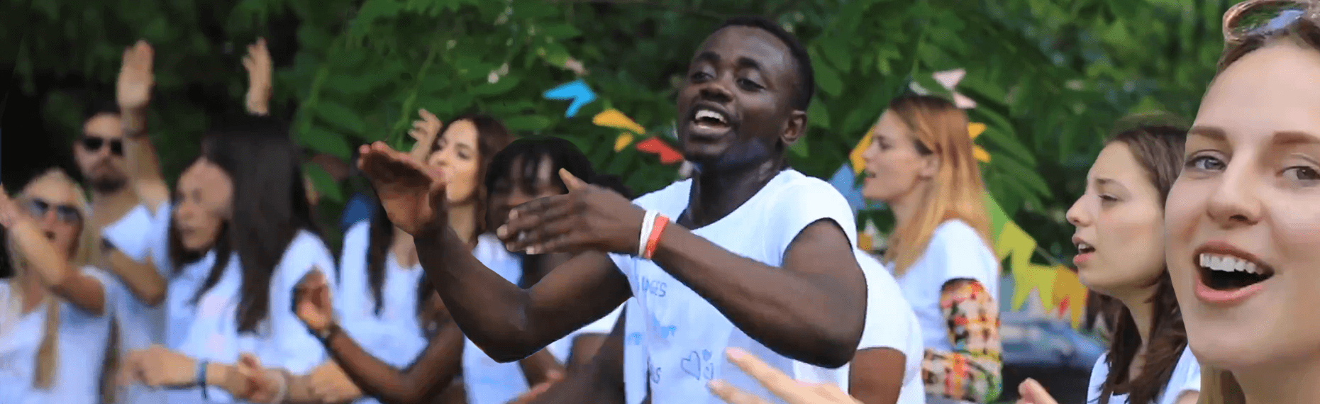 A group of young people singing and dancing while taking part in a youth Erasmus+ project called Bridges Not Walls