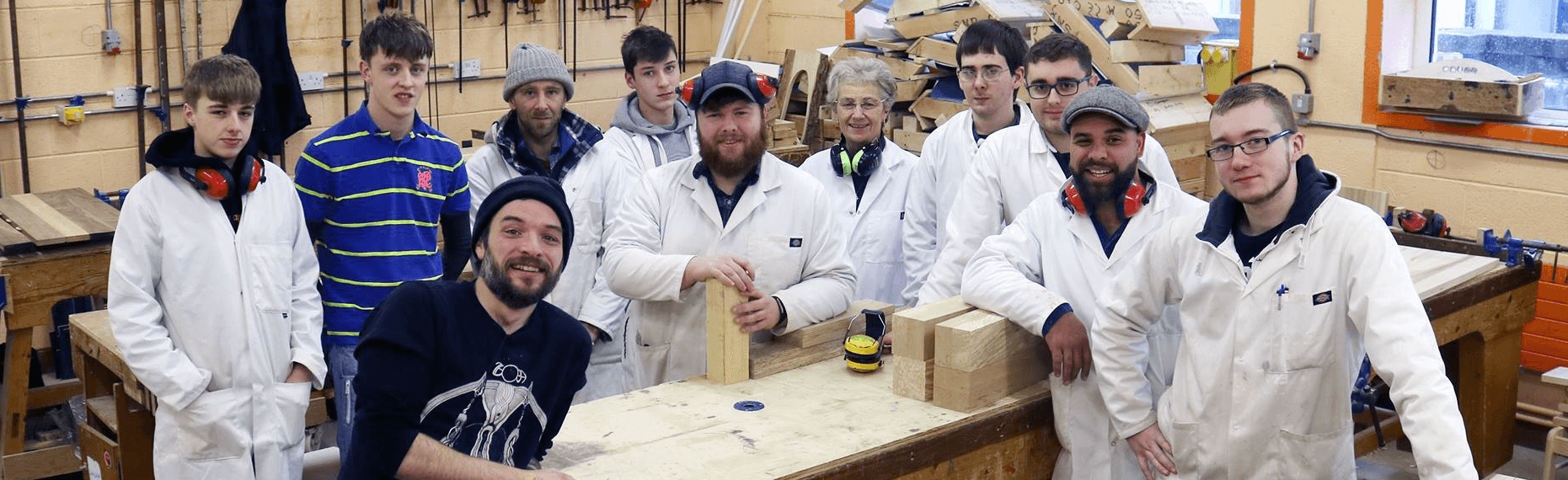 A group of students in vocational education learning more about woodwork