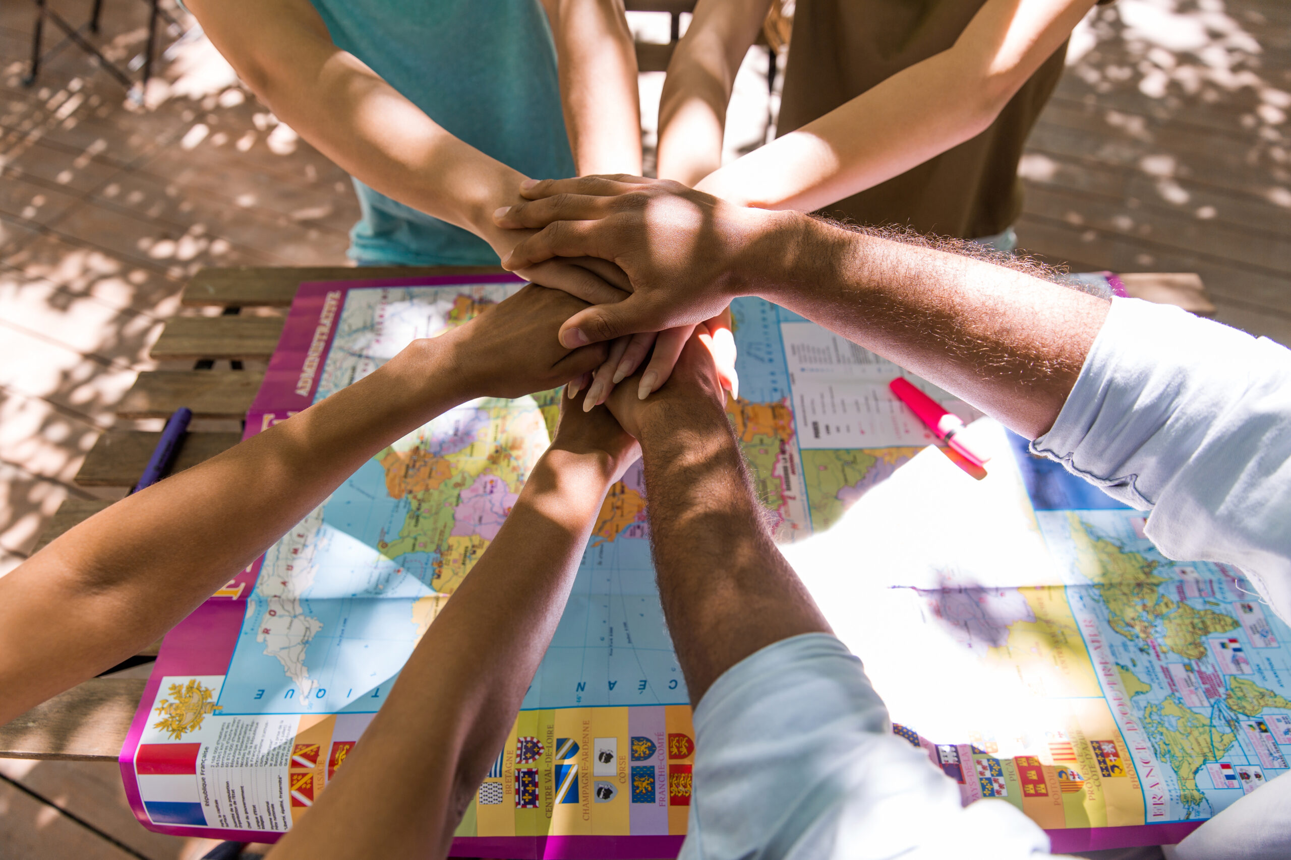 A stock image of multiple hands joined together in solidarity