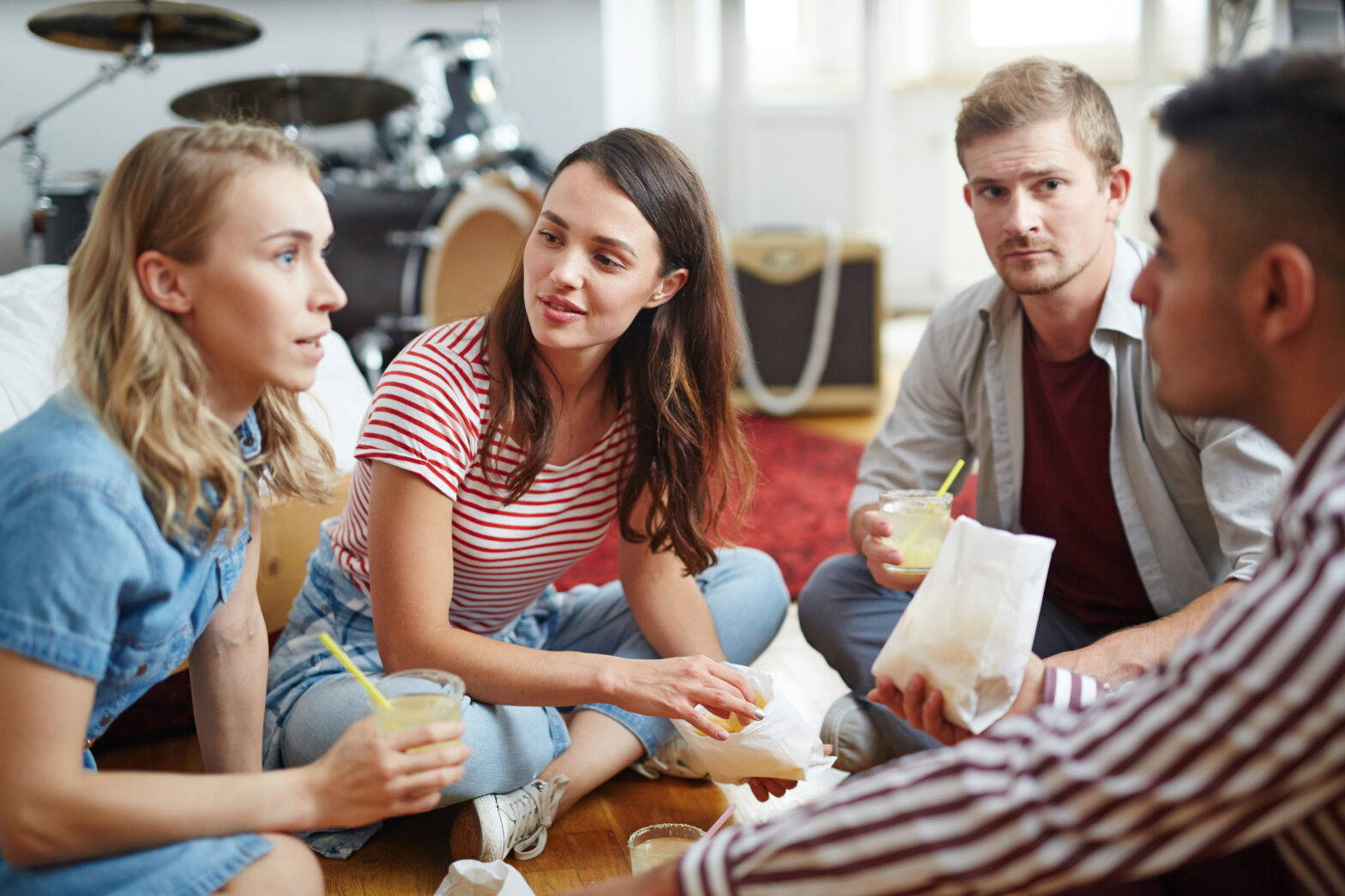 A stock image of young people having lunch while engaged in conversation