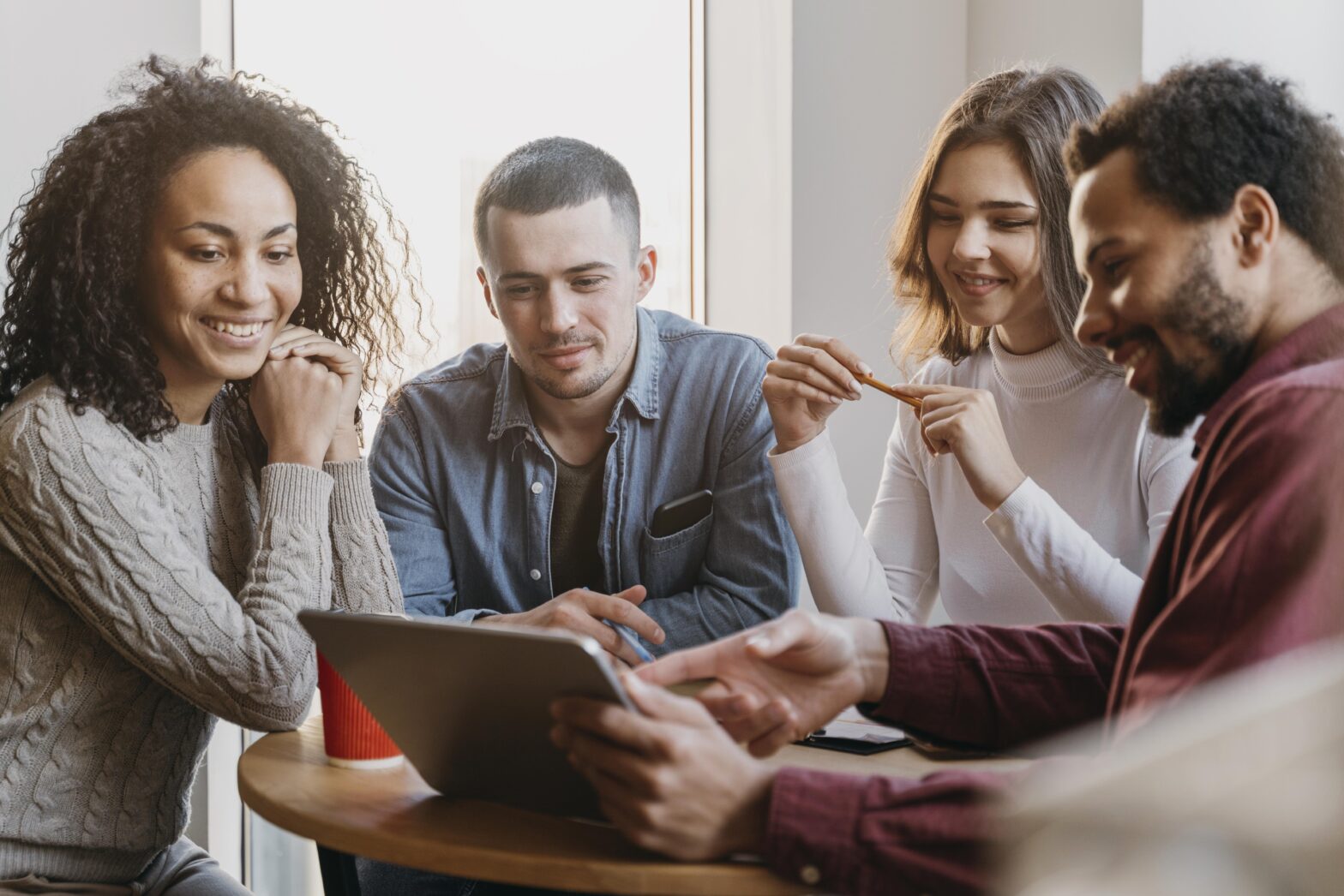 A stock image of 4 young people working on a project