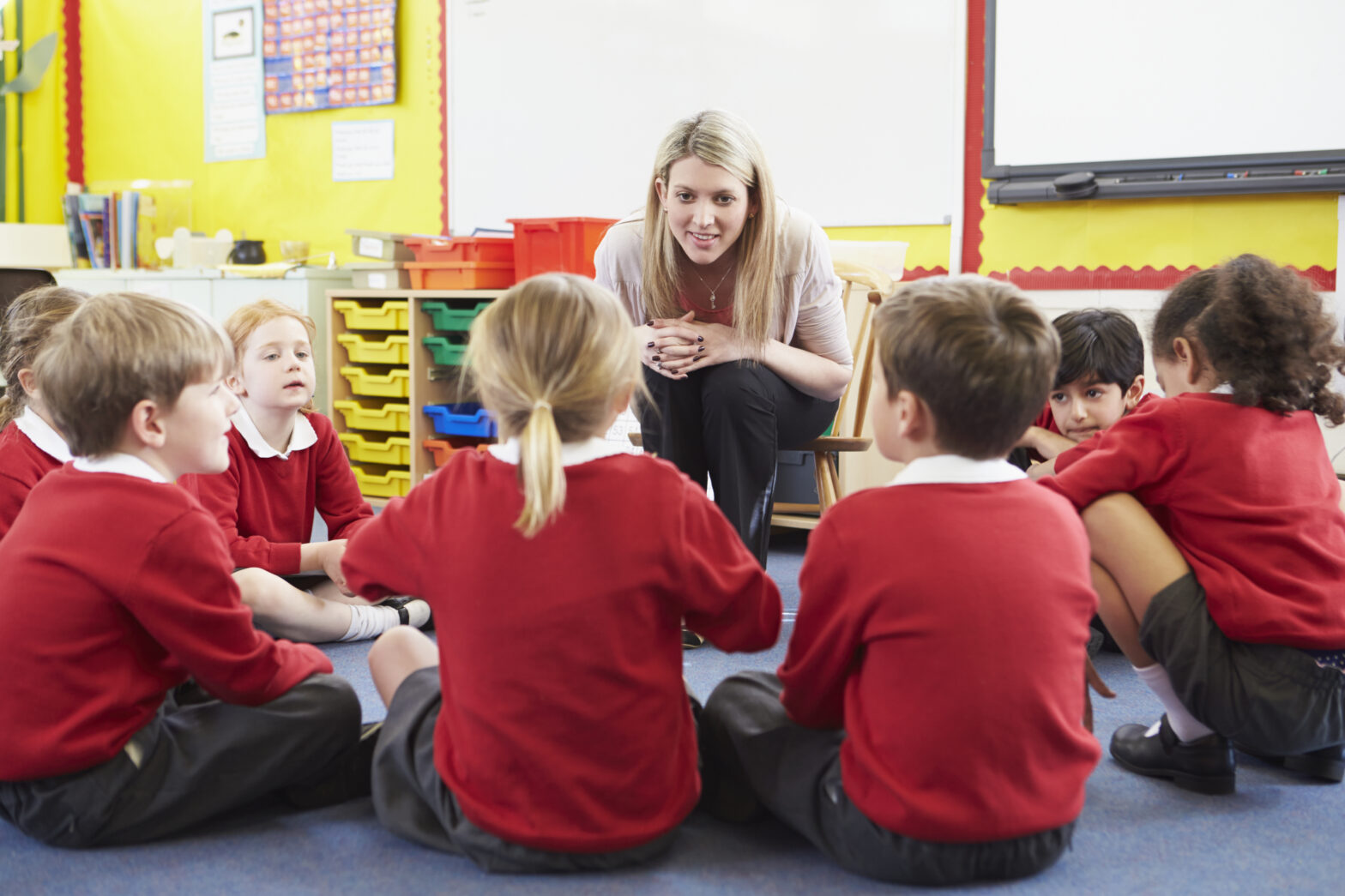 An image of a teacher sharing a story with her pupils